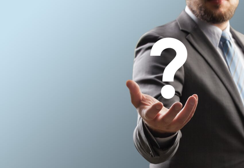 businessman holding a question mark